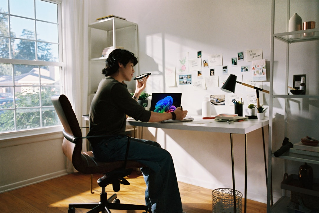 person-working-at-desk-with-laptop-and-phone-otduuluhh20